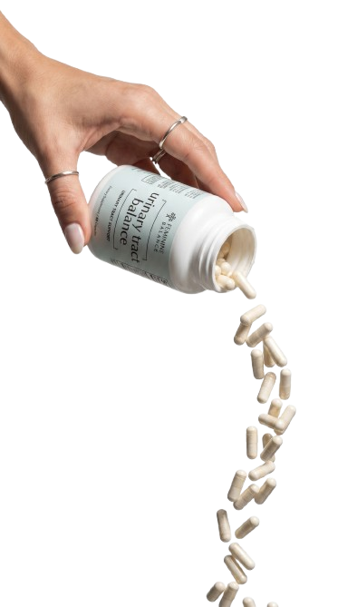 Hand pouring Urinary Tract Balance capsules from the bottle