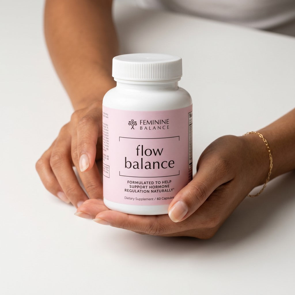 Hands holding a bottle of Flow Balance PMS and period support supplement